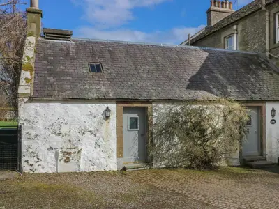 an old white cottage with a gray roof at Sweetpea Cottage in Wiston