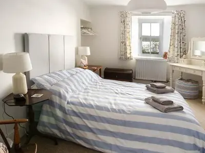 a bedroom with a bed with two towels on it at Fish House in Kirkcudbright