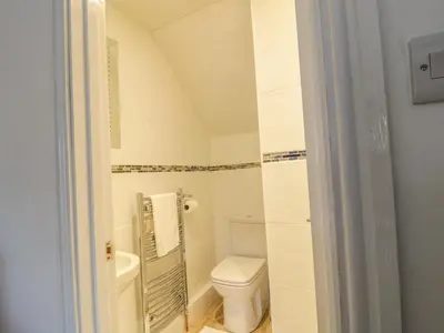 a bathroom with a toilet and a sink at 1 Rubby Banks Road in Cockermouth