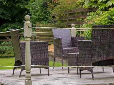 a group of chairs sitting on a wooden deck at Torkeld Holiday Cottage in Garlieston
