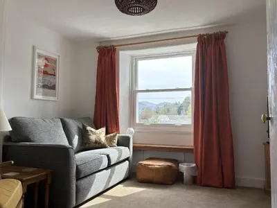 a living room with a couch and a window at Prospect Lodge in Portinscale