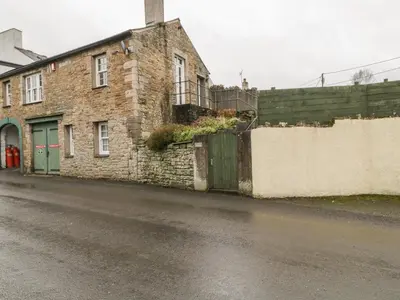 a brick building on the side of a street at Ale Cottage in Ireby