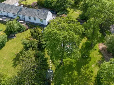 an overhead view of a house with a yard with trees at Mell View Cottage in Watermillock