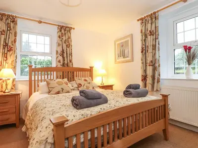 a bedroom with a bed with two towels on it at Coombe Cottage in Borrowdale Valley