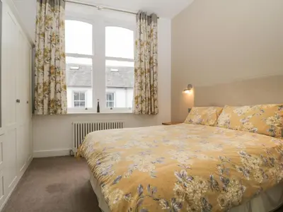 a bedroom with a bed and a large window at St Johns View in Keswick