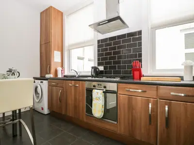 a kitchen with a sink and a stove top oven at St Johns View in Keswick