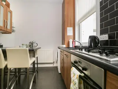 a kitchen with a stove and a counter top at St Johns View in Keswick