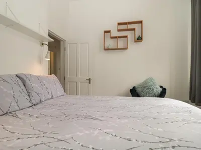 a bedroom with a bed with a white comforter at St Johns View in Keswick
