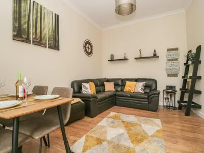 a living room with a couch and a table at St Johns View in Keswick