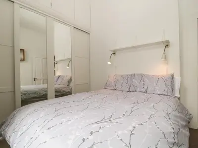 a bedroom with a bed and a large mirror at St Johns View in Keswick