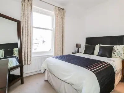 a bedroom with a large bed and a window at Helvellyn in Keswick