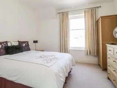 a bedroom with a large bed and a window at Helvellyn in Keswick