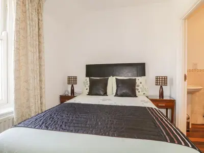 a bedroom with a large bed with a black headboard at Helvellyn in Keswick