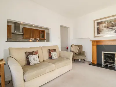 a living room with a couch and a fireplace at Helvellyn in Keswick