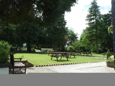 a group of picnic tables in a park at Whitbarrow Holiday Village Troutbeck 5 in Penruddock