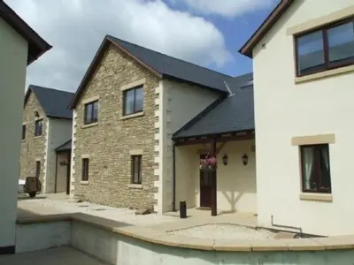 a large brick house with a driveway in front of it at Whitbarrow Holiday Village Troutbeck 5 in Penruddock
