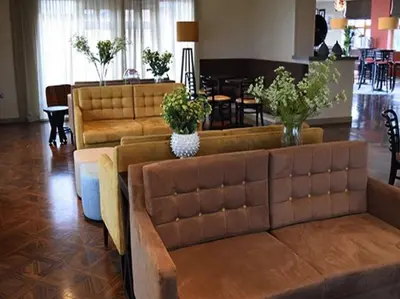 a living room with a couch and a dining room at Whitbarrow Holiday Village Troutbeck 5 in Penruddock
