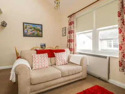 a living room with a couch and a window at Castlerigg in Keswick