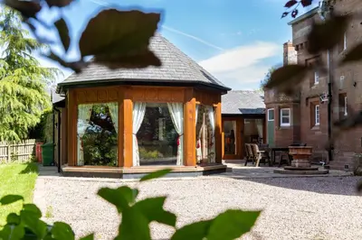 a gazebo in the courtyard of a house at Heads Nook Hall Cottage in Carlisle