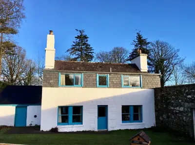 an old house with a chimney on top of it at Garden Cottage in Carsluith