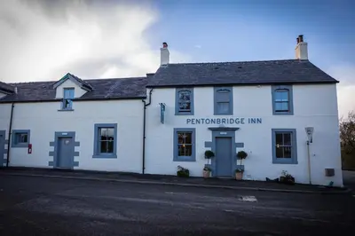 a white building with the entrance to the performance inn at Pentonbridge Inn - Restaurant with Rooms in Carlisle