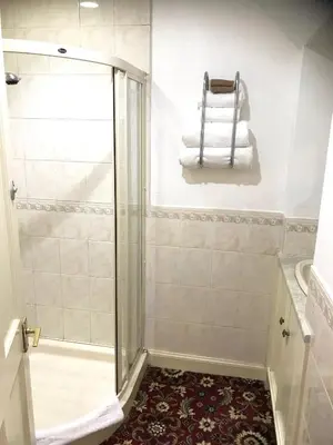 a bathroom with a shower with a glass door at Ferintosh Guest House in Dumfries