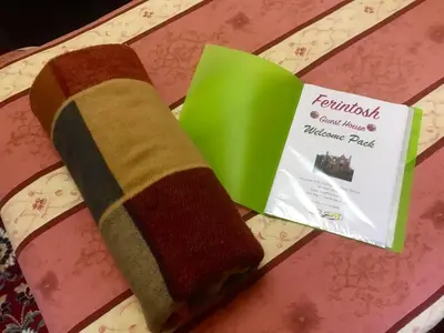 a towel on a plate with a package ofumespulse at Ferintosh Guest House in Dumfries