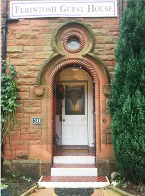 a front door of a brick house with a white door at Ferintosh Guest House in Dumfries