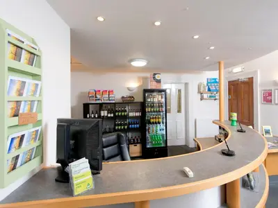 a bar in a store with a computer on a counter at YHA Buttermere in Buttermere