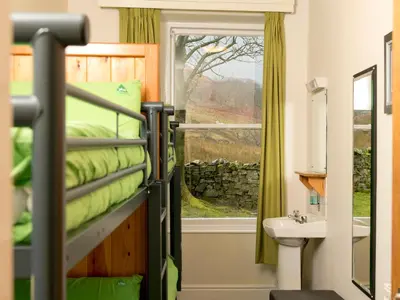 a bedroom with a bunk bed and a window at YHA Buttermere in Buttermere