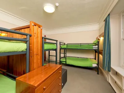 a room with three bunk beds and a desk at YHA Buttermere in Buttermere