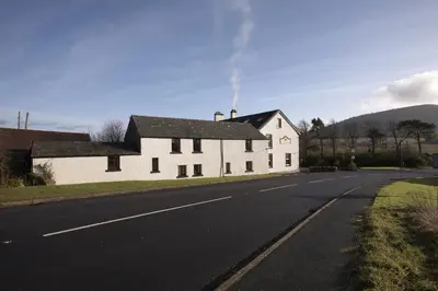 a white house on the side of a road at Troutbeck Inn in Troutbeck