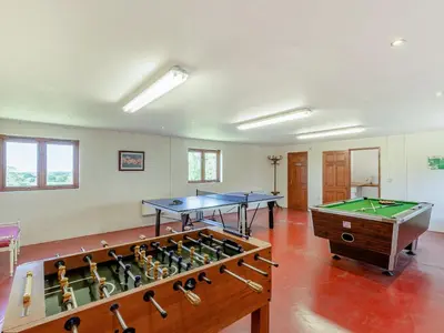 a room with two ping pong tables and a pool table at New Park Farm - Church Cottage in Ireby
