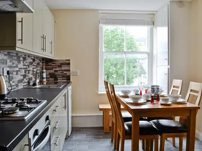 a kitchen with a table and chairs and a kitchen with a window at Walla Crag in Keswick