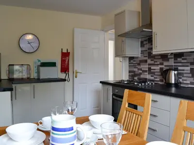 a kitchen with a table with cups and dishes on it at Walla Crag in Keswick