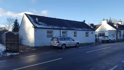 a car parked in front of a white house at Silver Ridge, 2 House O` Hill in Newton Stewart