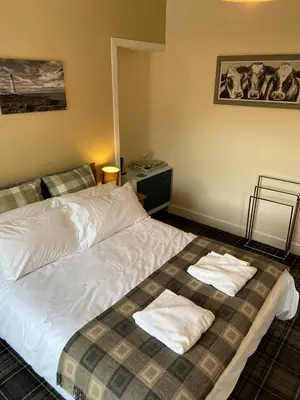 a bedroom with a bed with two towels on it at No 4 Portpatrick B&B in Portpatrick