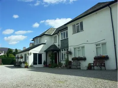 a large white house with a lot of windows at Rickerby Grange in Keswick