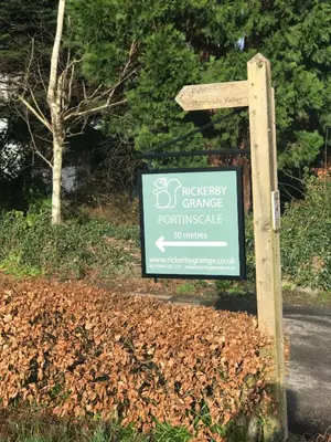a sign for a park on the side of a road at Rickerby Grange in Keswick