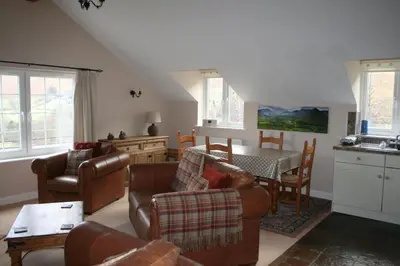a living room with a couch and chairs and a table at StoneyFell in Keswick