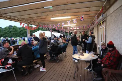 a group of people sitting at tables on a deck at IntentsGP @ Isle of Man TT, IOMTT in Douglas