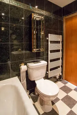 a bathroom with a toilet and a bath tub at Dairy Cottage in Ayr