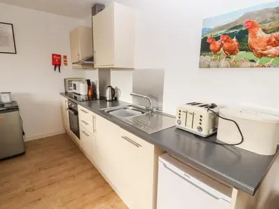 a kitchen with a sink and a counter top at Woodpecker in Ivegill