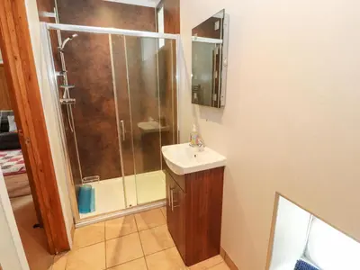 a bathroom with a shower and a sink at The Hayloft in Keswick