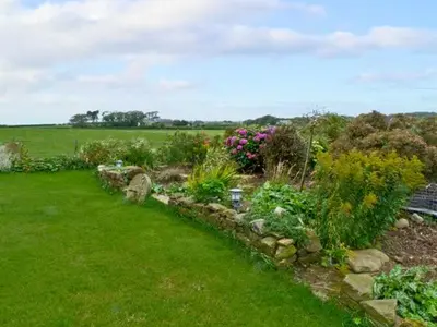 a garden with flowers and plants in a field at Surprise View in Holmrook