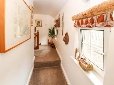 a staircase in a house with a window at Fell Cottage in Wigton