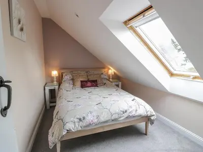 a bedroom with a bed and a window at The Bothy in Mainsriddle