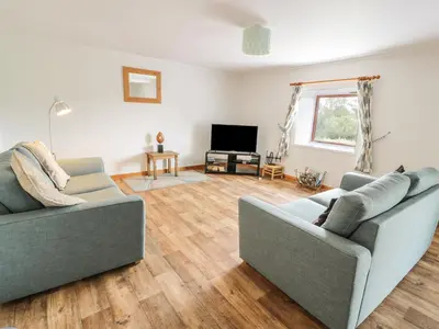 a living room with two couches and a television at The Dairy in Newton Stewart
