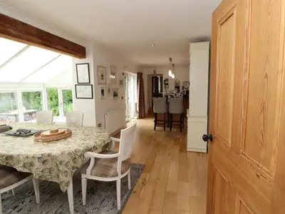 a kitchen and dining room with a table and chairs at North Lodge in Annan
