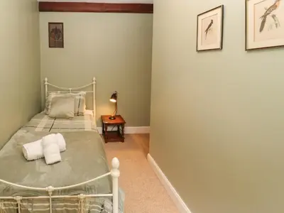 a bedroom with a bed and a side table at 1 Field Foot Cottage in Ambleside